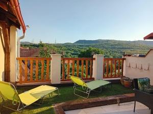 a balcony with chairs and a view of the mountains at Apartmán Merkur in Kadaň
