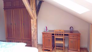 a bedroom with a desk and a chair in a attic at Apartmán Merkur in Kadaň +4 photos