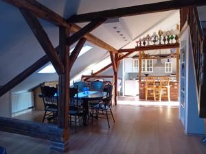 a dining room with a table and chairs at Apartmán Merkur in Kadaň