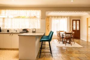 a kitchen and dining room with a table and chairs at Spacious Frankston Retreat in Frankston