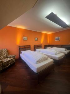 a room with four beds and a couch in it at Hotel Waldblick BSR Garten mit Pavillons im Schwarzwald, ideal für Paare, Familien, Hunde in Donaueschingen