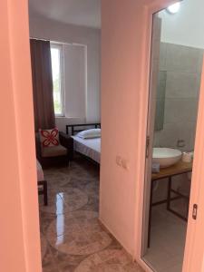a room with a bed and a bathroom with a sink at Olympia Ureki Guria Street 24-26 in Ureki +66 photos