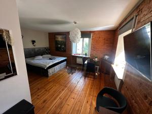 a bedroom with a bed and a desk and a window at R.Wolf castle in Gulbene
