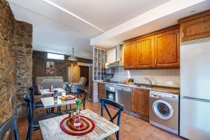 a kitchen and dining room with a table and chairs at El Regreso in Jarilla