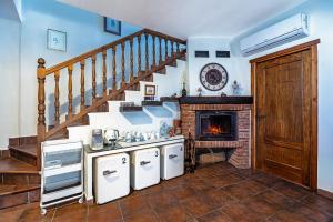 a kitchen with a staircase and a fireplace at El Regreso in Jarilla