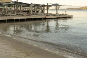 a dock with tables and chairs on the water at Costa Farilya Special Class Hotel Bodrum in Gundogan