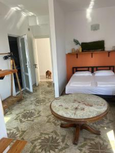 a bedroom with a bed and a table in a room at Olympia Ureki Guria Street 24-26 in Ureki