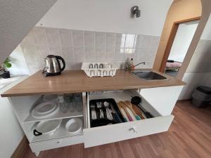 a kitchen with a sink and a counter top at Comfortable and functional apartment in Kretzschau