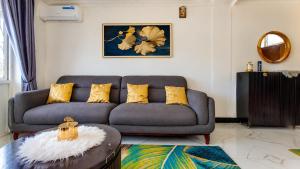a living room with a couch and a table at City Getaway Apartments in Zanzibar City