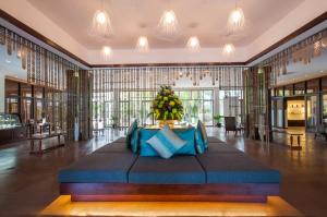 a large room with a bed in the middle of it at Lotus Blanc Resort in Siem Reap