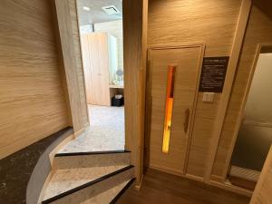 a door in a building with a sign on it at Hotel Ayung 大人専用 in Sumoto +62 photos
