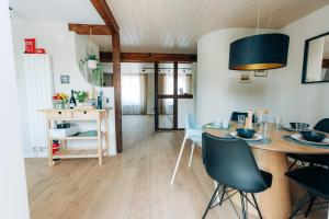 a dining room and living room with a table and chairs at 120sqm Duplex Apartment with AirC Free Parking Family & Business in Biel