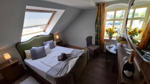 a small bedroom with a bed and a window at Wein-Hotel Auberge Mistral in Freiberg