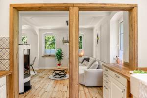 an open kitchen and living room with a couch at Ferienwohnung Schwarzmühle 2 in Neuer Anbau