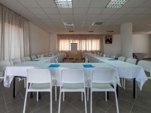 a conference room with a long table and white chairs at Lunja Village - Agadir in Taghazout +110 photos