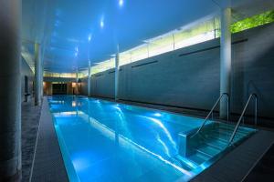 a swimming pool in a building with blue lighting at Park Hotel Kenmare in Kenmare
