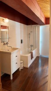 a bathroom with a tub and a sink and a shower at Plein Ciel - Hôtel d'altitude à 1800m in Champéry