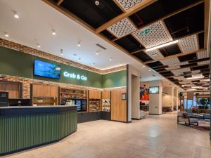 a fast food restaurant with a counter in a lobby at Ibis Tashkent Index in Tashkent