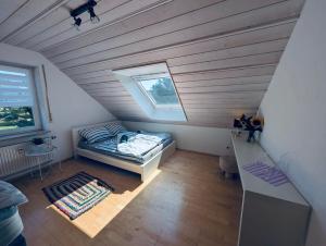 a attic room with a bed and a window at Ferienapartment Naturblick in Hausen