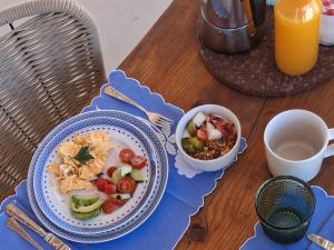 a table with a plate of food and a bowl of salad at Luz Retreat in Luz de Tavira