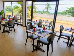 a restaurant with tables and chairs and a large window at Junto Al Mar - Mini suite in San-Pédro