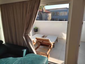 a balcony with a couch and chairs and a window at Deluxe Dino room & studio apartment by Adex travel in Zadar