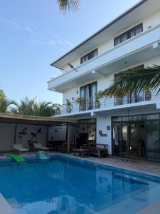 a villa with a swimming pool in front of a building at Limiria Residence in Nungwi