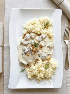 a plate of pasta with mushroom sauce and a fork at Queens Safehouse in Brozany +10 photos