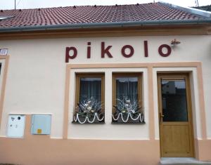 a building with a sign that reads pirolo at Penzion Pikolo in Nové Mesto nad Váhom