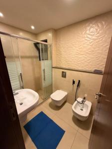 a bathroom with a sink and a toilet at Nine homes in Amman