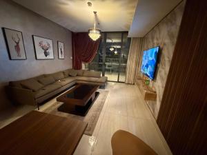 a living room with a couch and a tv at Nine homes in Amman