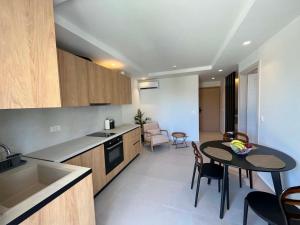 a kitchen and dining room with a table and a kitchen and a dining room at Nestia Residences in Kardamaina