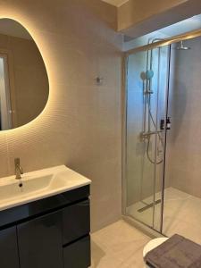 a bathroom with a sink and a shower at Nestia Residences in Kardamaina