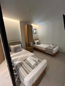 a hotel room with two beds in a room at Nestia Residences in Kardamaina