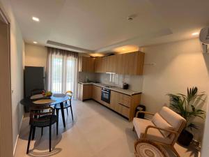 a kitchen and a living room with a table and chairs at Nestia Residences in Kardamaina
