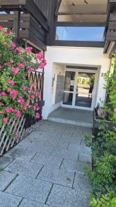 a front door of a house with pink flowers at Ruhiges Nest in Bad Endorf