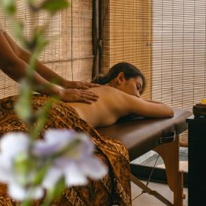 a man getting a back massage in a chair at SHIBUMI - Private Pool & Spa Boutique Villa in Ubud