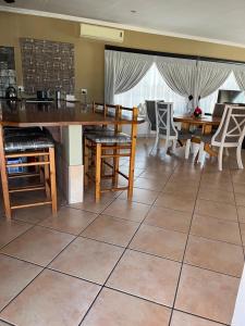 a dining room with a table and chairs at Diamo Guest House in Roodeplaat +5 photos
