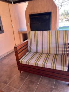 a couch sitting on a tiled floor in a room at Diamo Guest House in Roodeplaat