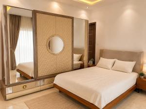 a bedroom with a large mirror and a bed at house for rent in Saly Portudal +1 photo