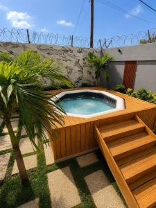 a hot tub in a garden with a palm tree at house for rent in Saly Portudal