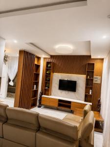a living room with a couch and a flat screen tv at house for rent in Saly Portudal