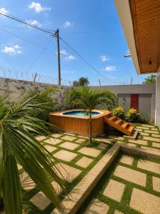 a garden with a swimming pool in a yard at house for rent in Saly Portudal