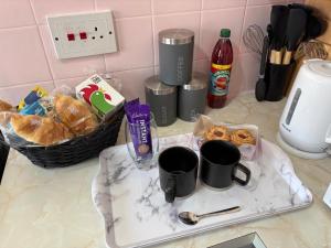 a tray with cups and pastries on a kitchen counter at The Paddocks in Bicton +5 photos