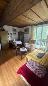 a living room with a couch and a table at Cosy Lodge un rifugio romantico nel cuore delle Dolomiti in Madonna di Campiglio