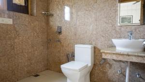 a bathroom with a toilet and a sink at Green View Hotel in Leh