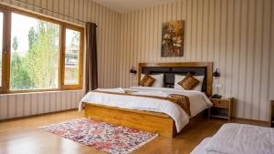 a bedroom with a large bed and a window at Green View Hotel in Leh