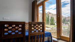 a room with a table and two chairs and a window at Green View Hotel in Leh