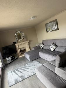 a living room with a couch and a fireplace at Suzies Escape in Bovevagh