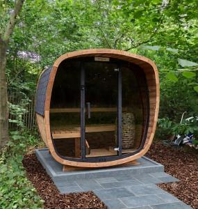 a large wooden barrel sitting on some steps in a garden at Sweetwater Privé Wellness in Oud-Heverlee